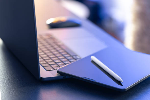 istock Digital tablet, stylus pen and laptop on the desktop, close up. 1816370462