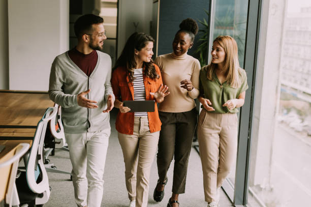 istock Young multiethnic startup team walking in the modern office 1816370995