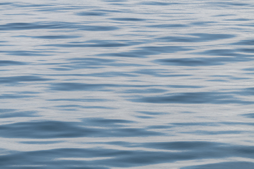 Small ocean waves and ripples creating an abstract pattern