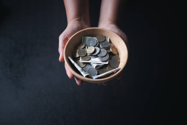 istock One tenth or tithe is basis on which Bible teaches us to give one tenth of first fruit to God. coins with Holy Bible. Biblical concept of Christian offering, generosity, and giving tithes in church. 1816389257