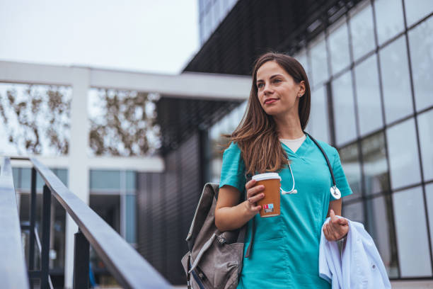 istock Smiling female surgeon standing outdoors while looking away. 1816402545