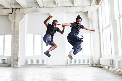 Two black men dancing together at dance lesson in exercise room