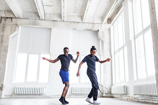 Two black men dancing together at dance lesson in exercise room