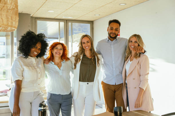 istock Multiethnic business team smiling while standing together in the office. 1816408422