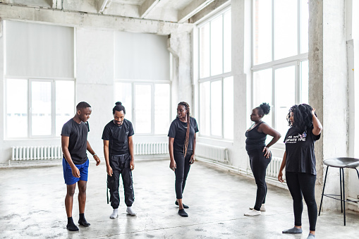 Young black males and females dancing in exercise room before dance performance. Dance rehearsal