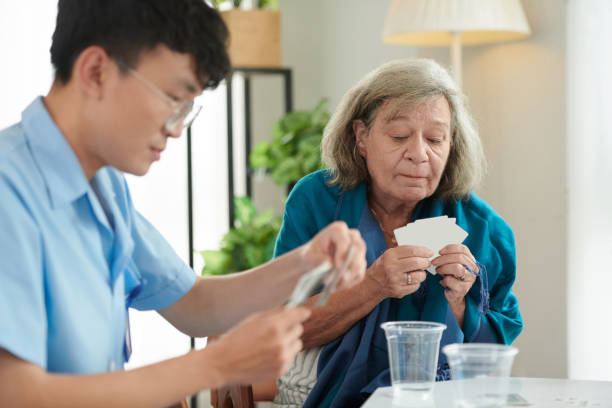 istock Old Woman Playing Cards with Nurse 1816410589