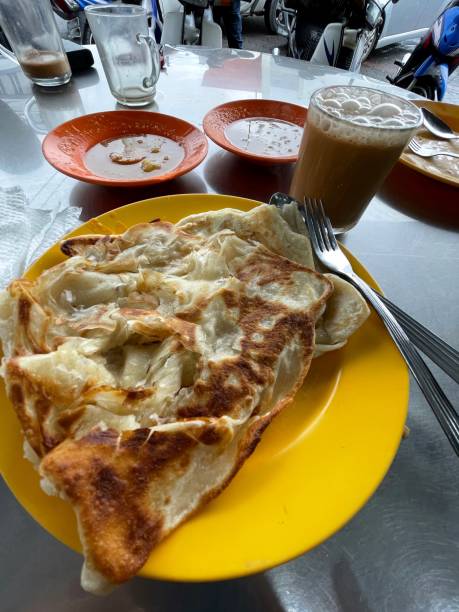 Malaysian dish for breakfast, Roti Canai and Teh Tarik Malaysian dish for breakfast, Roti Canai and Teh Tarik roti canai stock pictures, royalty-free photos & images