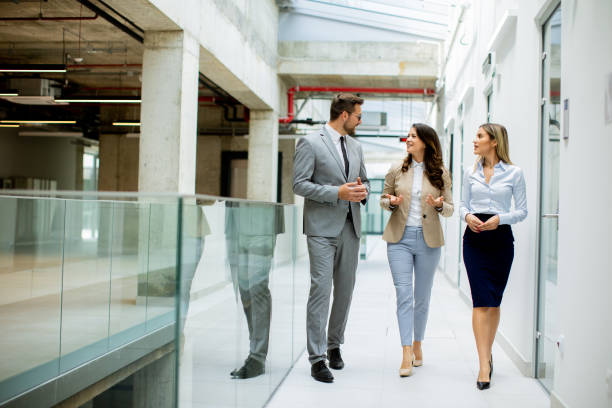 istock Young startup team have a discussion while walking in the modern office corridor 1816420764