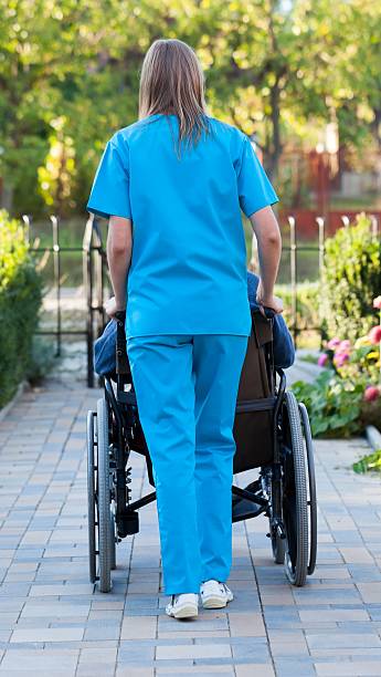 istock Pushing the patient in wheelchair 181642314