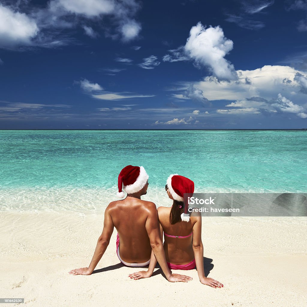 Casal na santa's hat na praia em Maldivas - Foto de stock de Adulto royalty-free