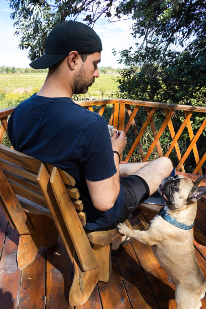 istock having coffee on the balcony with her dog 1816434028
