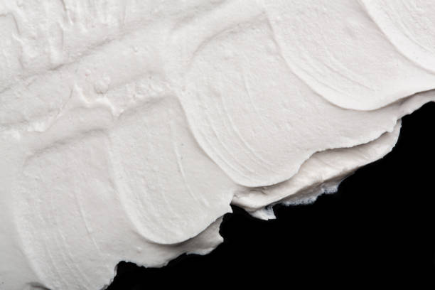 istock Structural plaster white on a black background. White Cream. paint smear. Plasticine 1816443585