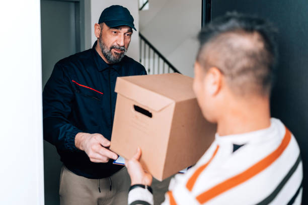 istock Cheerful exchange at the doorstep between a delivery man and a customer 1816445266
