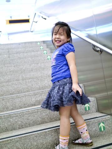 Close-up portrait of a beautiful cute girl with smiling on stair indoor