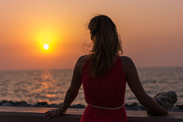 istock Girl looking at sunset 181647212