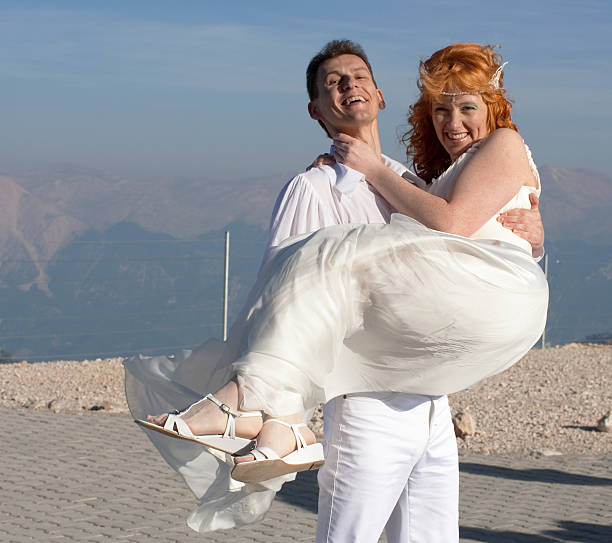 Newlyweds pose near the wedding arch