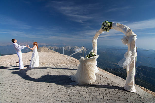 Newlyweds pose near the wedding arch
