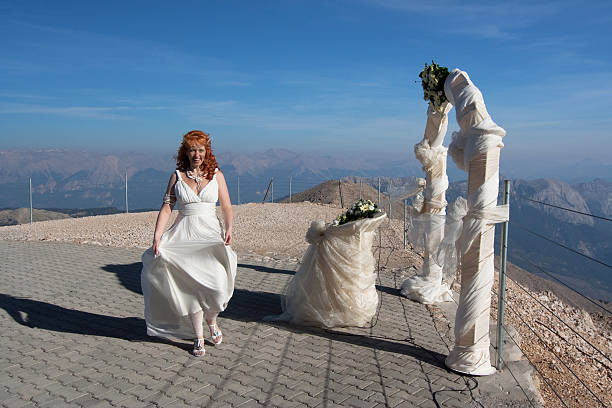 istock Newlyweds pose near the wedding arch 181647564