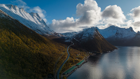 Aerial drone photo of the small island fishing town of Husoy on Senja, Norway.  A fishing village located in the Arctic Circle of Northern Norway.  Shot witha a DJI Air 2s