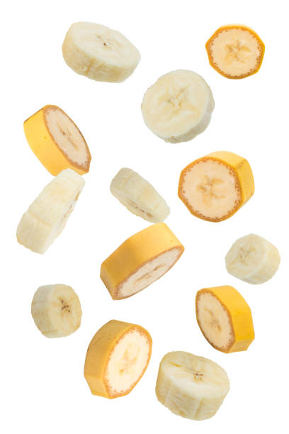 istock Flying fruits. Falling sliced banana fruit isolated on white background with clipping path as package design element. 1816484979