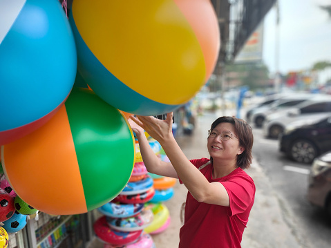 HOCHIMINH CITY, VIETNAM - JANUARY 22, 2022: Afternoon at the hot air balloon festival celebrating the founding of Thu Duc city above Thu Thiem tunnel. Technicians are inflating hot air balloons