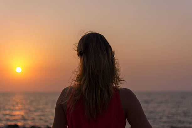 istock Girl looking at sunset 181650279