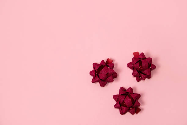 istock Red glitter bows on pink background 1816503557