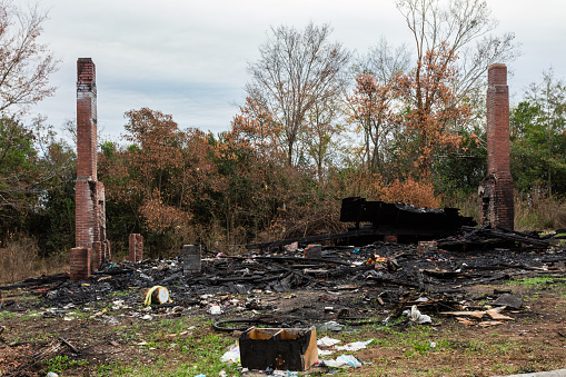 Burned remains of a house with two chimneys in the deep rural south