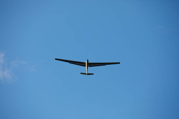Ultralight Glider Against Clear Blue Sky.