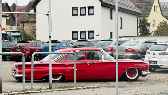 Ludwigsburg, Germany - November, 22nd -  2023: Large red American old-timer publicly parked.