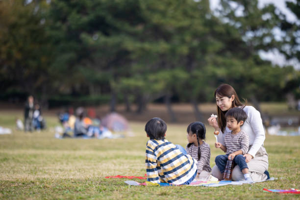 Family having lunch in public park