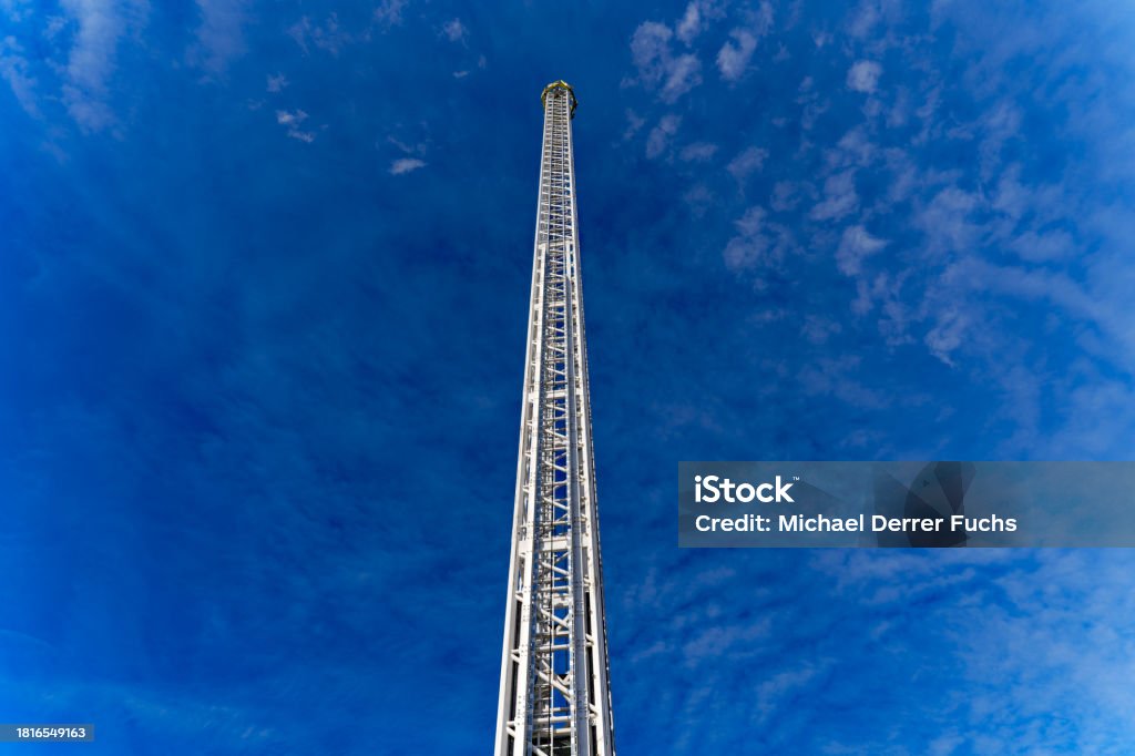 Scenic view of fair ride tower at Swiss town with blue sky background. Fun fair named Züri Fäscht at City of Zürich with fair ride named Skyfall on a sunny summer evening. Photo taken July 7th, 2023, Zurich, Switzerland. Amusement Park Ride Stock Photo