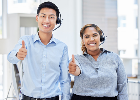 Portrait, call centre and people with thumbs up for team success, support or customer service excellence. Telemarketing, group smile and like hand emoji for diversity, goals and thank you for sales.