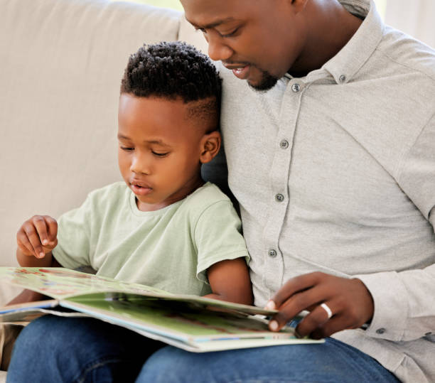 istock Father, reading and child with book in home on sofa with development of education, learning and knowledge. Happy dad, teaching and show kid storytelling in books and relax in living room on couch 1816565959