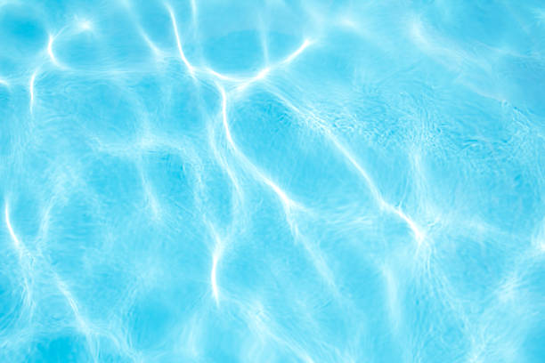 istock Blue water in swimming pool with sun reflections 1816566571