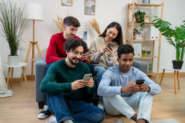 istock Multiethnic group of friends sitting on the sofa and using smartphones 1816566583