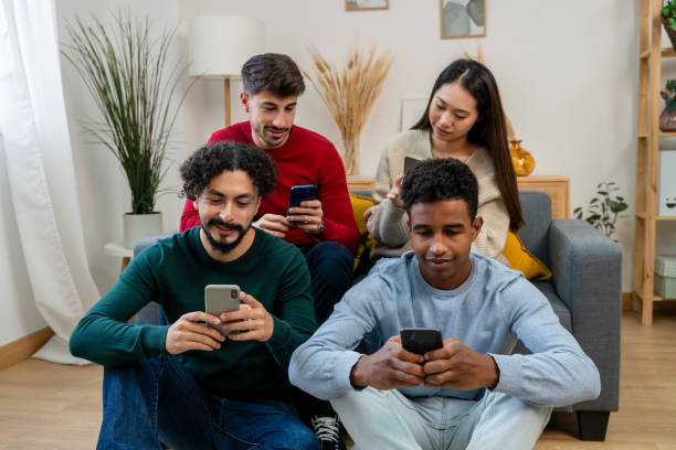 istock Multiethnic group of friends sitting on the sofa and using smartphones 1816570451