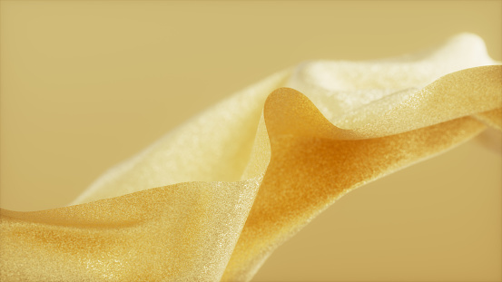 Abstract gold colored flowing fabric