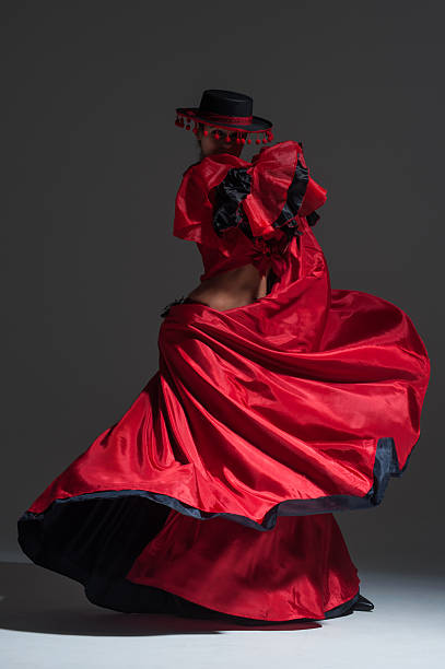 Woman in beautifull red dress dancing at studio stock photo