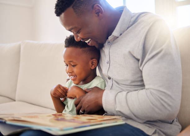 istock African, father and child in home reading book on sofa with development of language, education and learning. Happy dad, teaching and show kid a storytelling in books and relax in living room on couch 1816579073