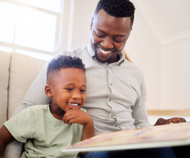 istock Happy dad, reading and child in home with a book on sofa for development of language, education and learning. Father, teaching and show kid a storytelling in books and relax in living room on couch 1816579079