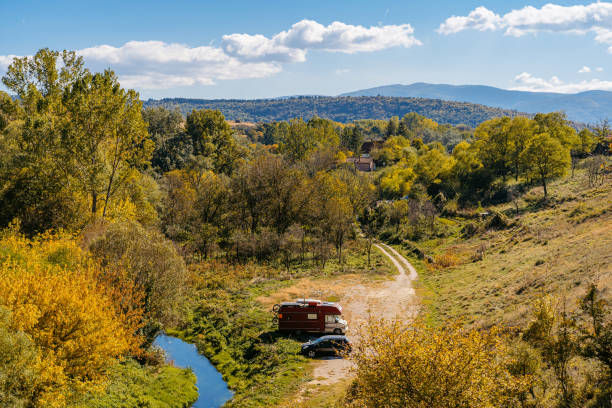 Campervan and a car parked on the mountain in Serbia.