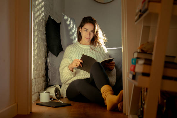istock Young mexican woman at home reading 1816592472