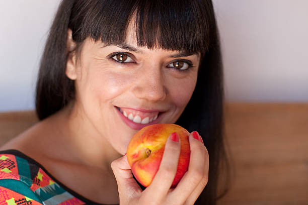 istock Cute woman with a nectarine 181659449