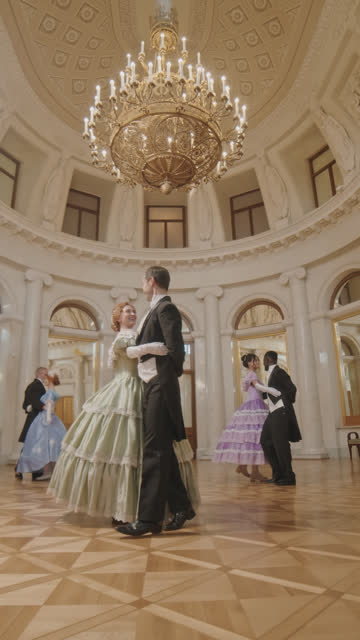 People in Medieval Outfits Waltzing in Ballroom