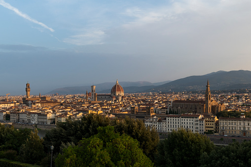 Expansive, panoramic view of Florence, Italy and its two principal landmarks: The Florence Duomo Cathedral and Badia Fiorentina church.