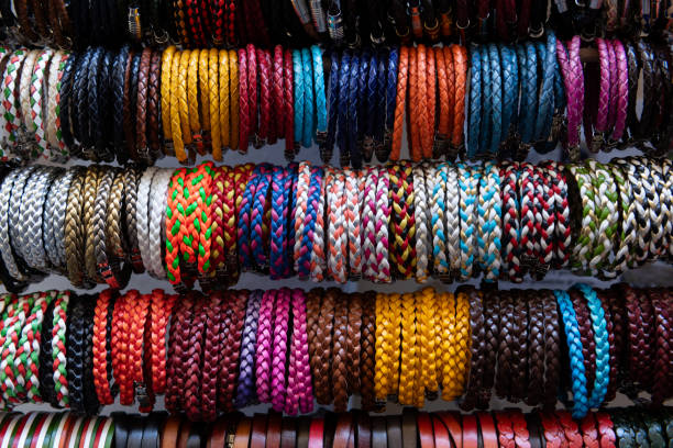 A variety of colorful, braided Italian leather bracelets displayed at an outdoor market in Florence, Italy.