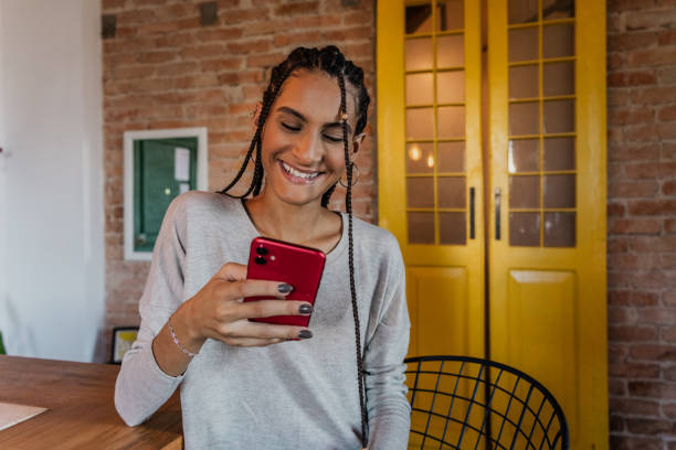 istock Young woman using mobile phone at home 1816614318