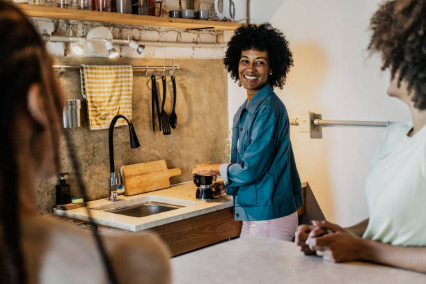 istock Mother preparing coffee and talking to daughters in the kitchen at home 1816614899
