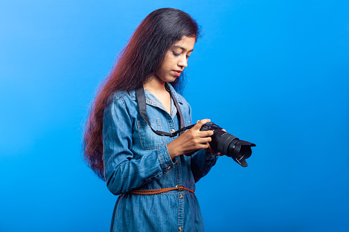 indian girl holding digital camera